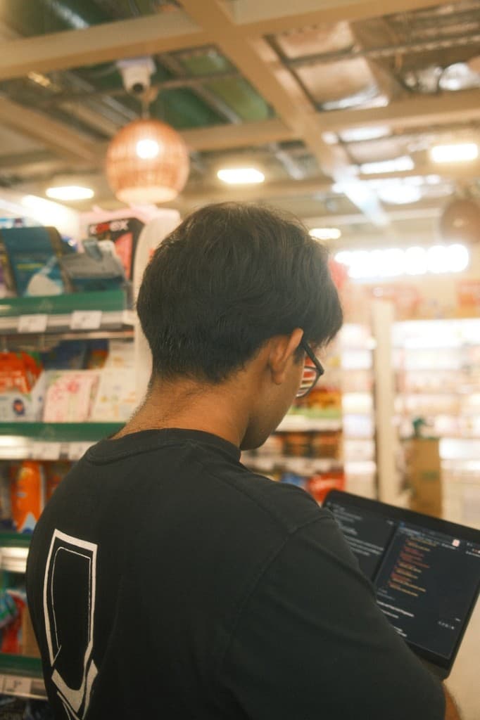 Rudy working on a laptop, seen from behind